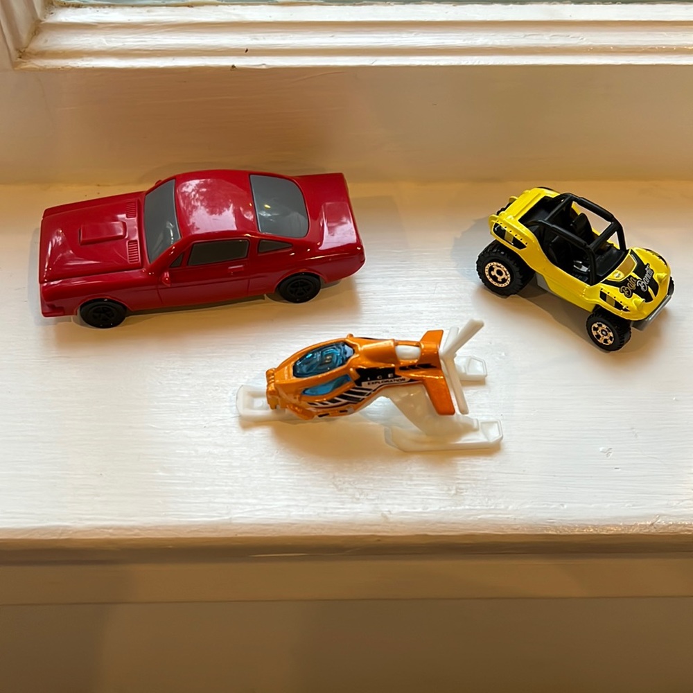 Two toy cars and a toy chopper
